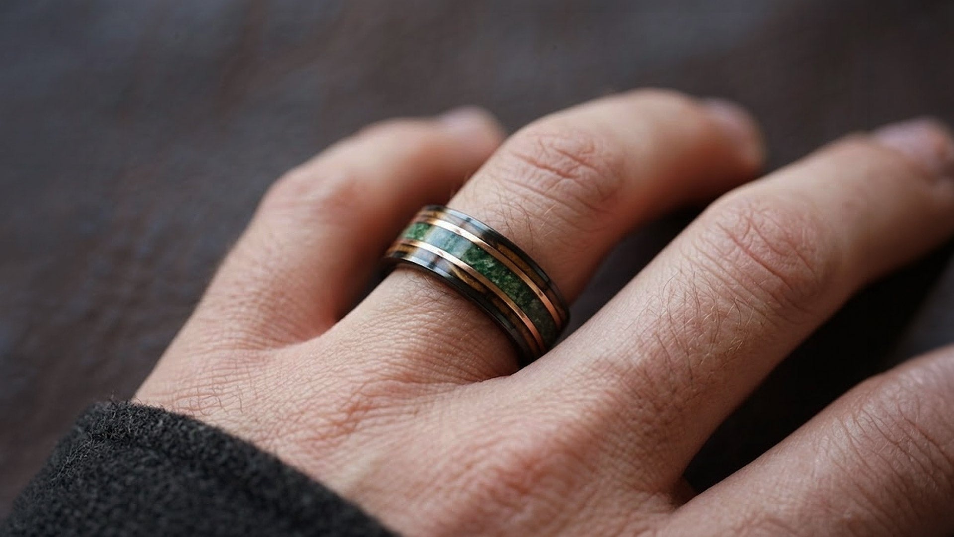 Moss Agate Wedding Band on natural stone background