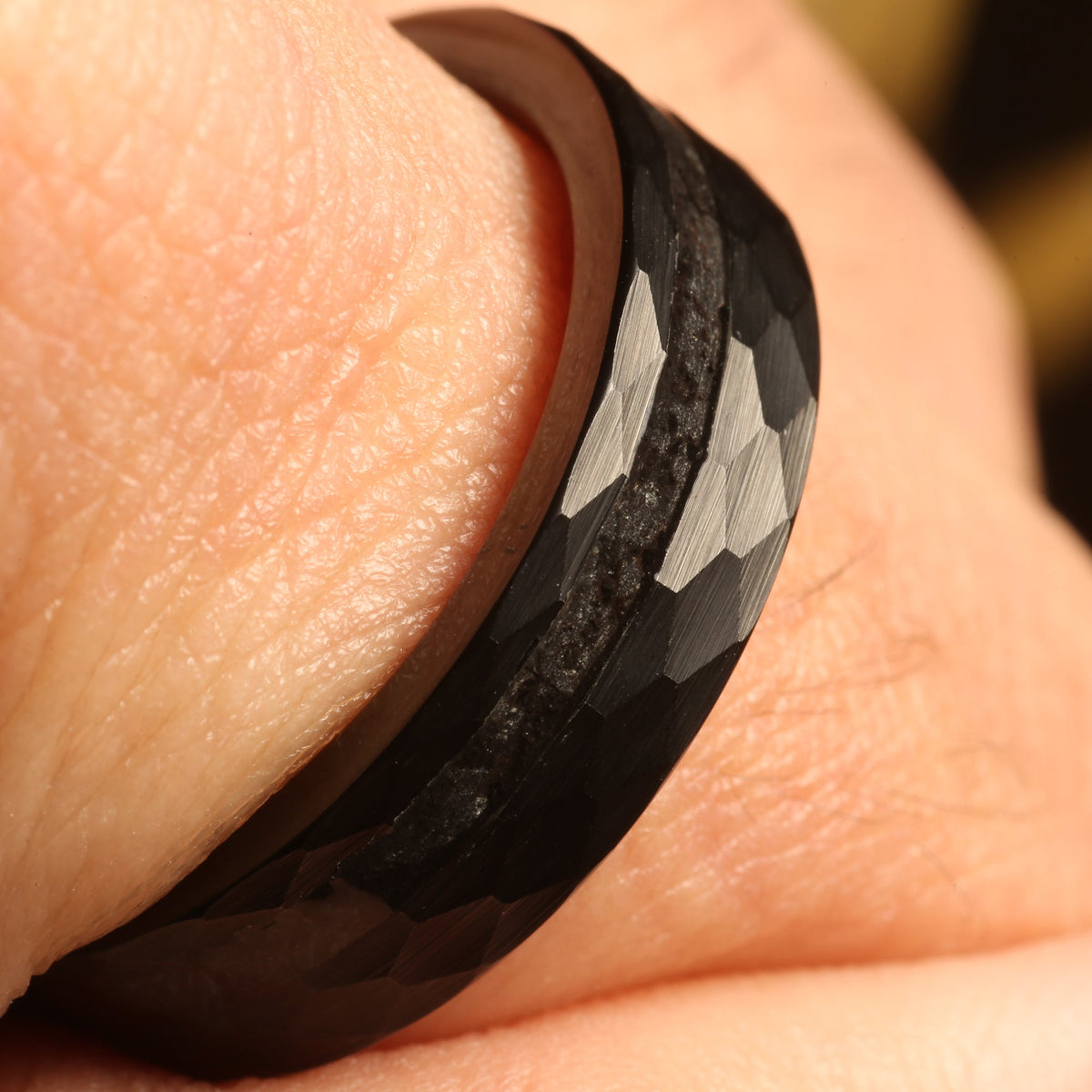 Black tungsten meteorite wedding band with hammered finish