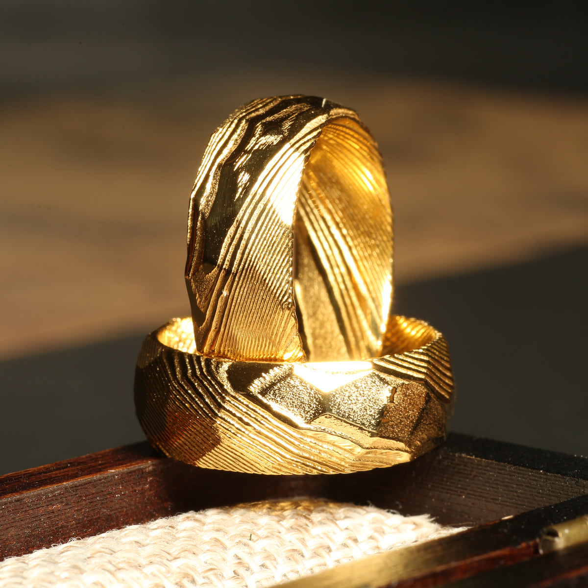 Gold Damascus wedding ring for men with forged texture