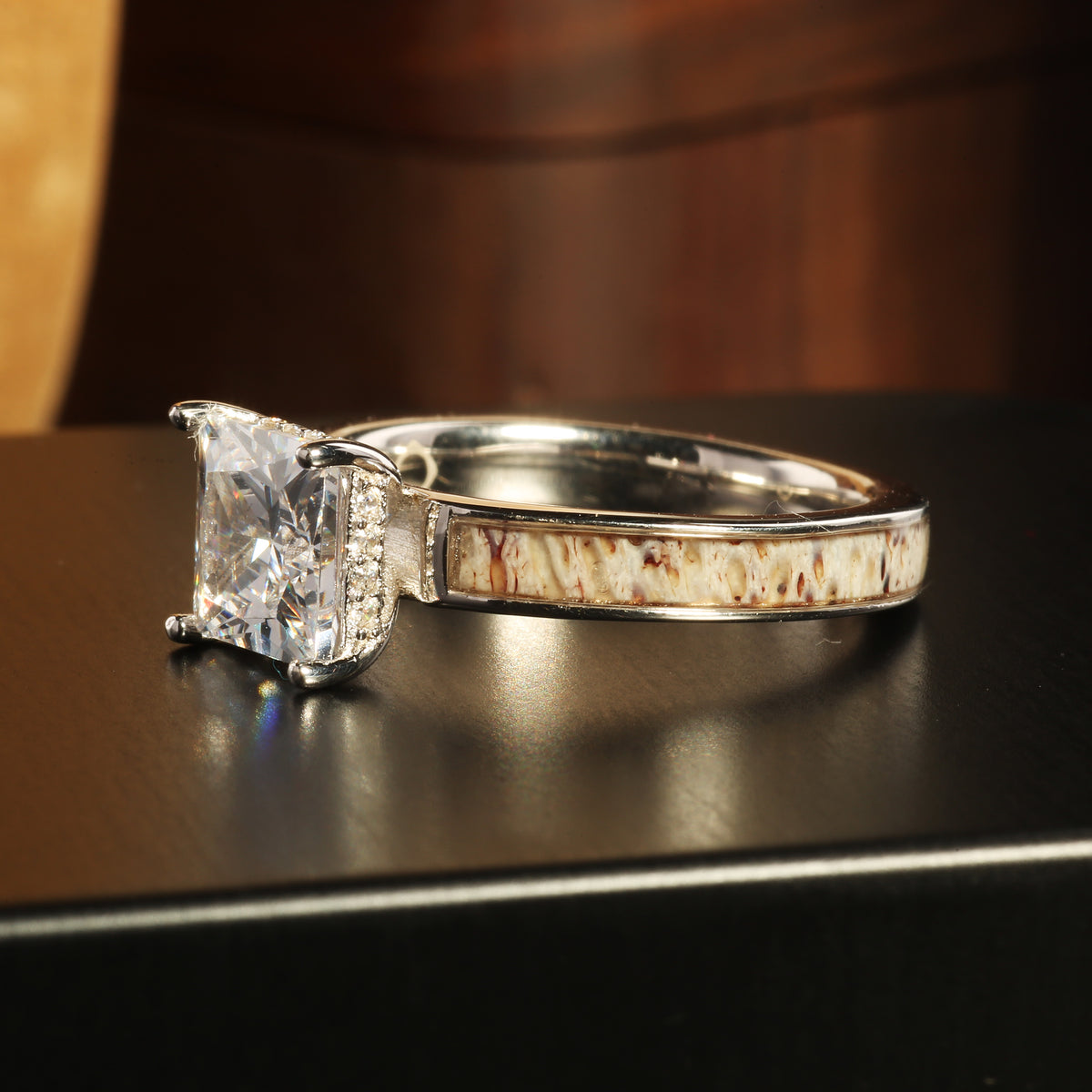 His black tungsten and her silver wedding rings with deer antler