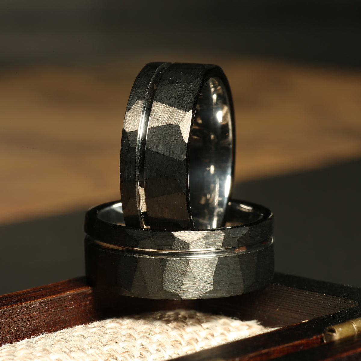 Men’s black hammered tungsten wedding band with silver strip