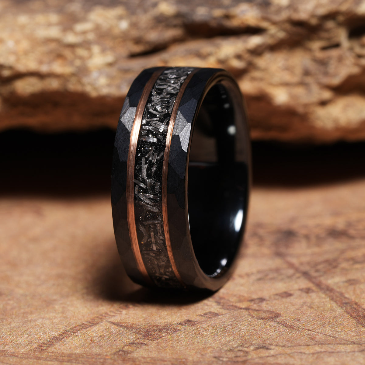 Men’s black tungsten meteorite band with warm rose gold contrast