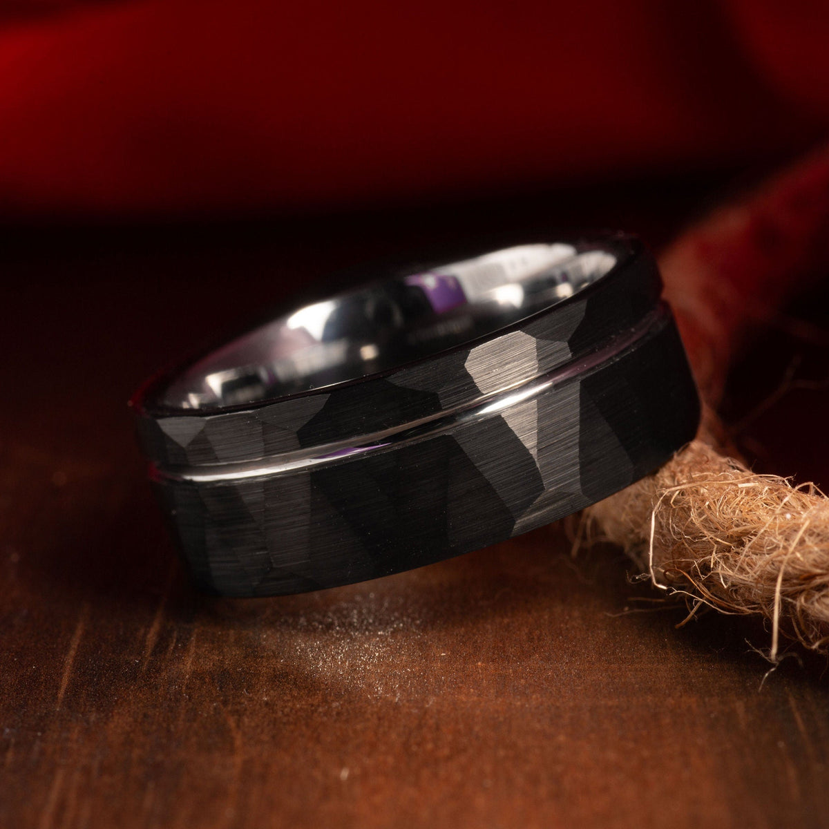 Men’s black tungsten wedding band with silver strip detail